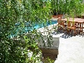 Sun lounges, dining table and chairs at the pool